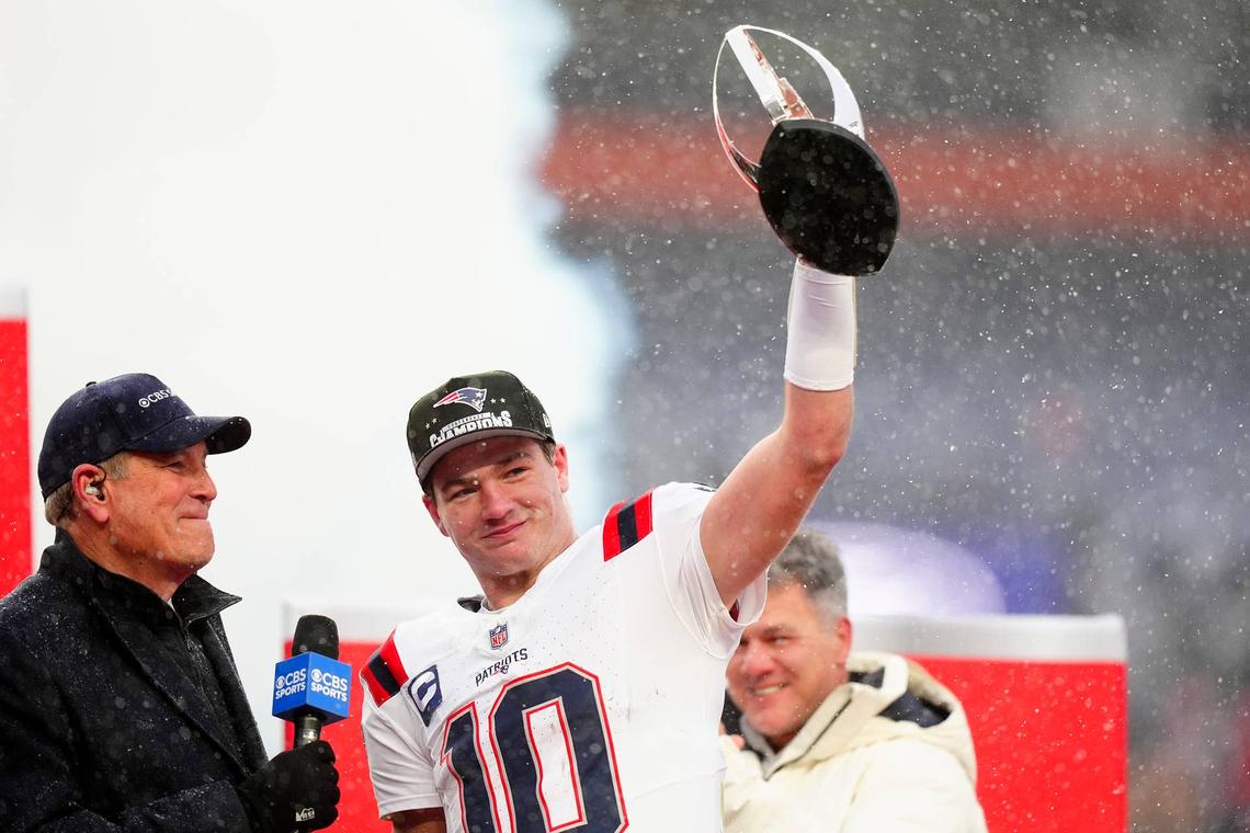 New England Patriots quarterback Drake Maye holds the AFC Championship trophy while speaking to the media after defeating the Denver Broncos in the 2026 AFC Championship Game at Empower Field at Mile High. Mandatory Credit: Ron Chenoy-Imagn Images