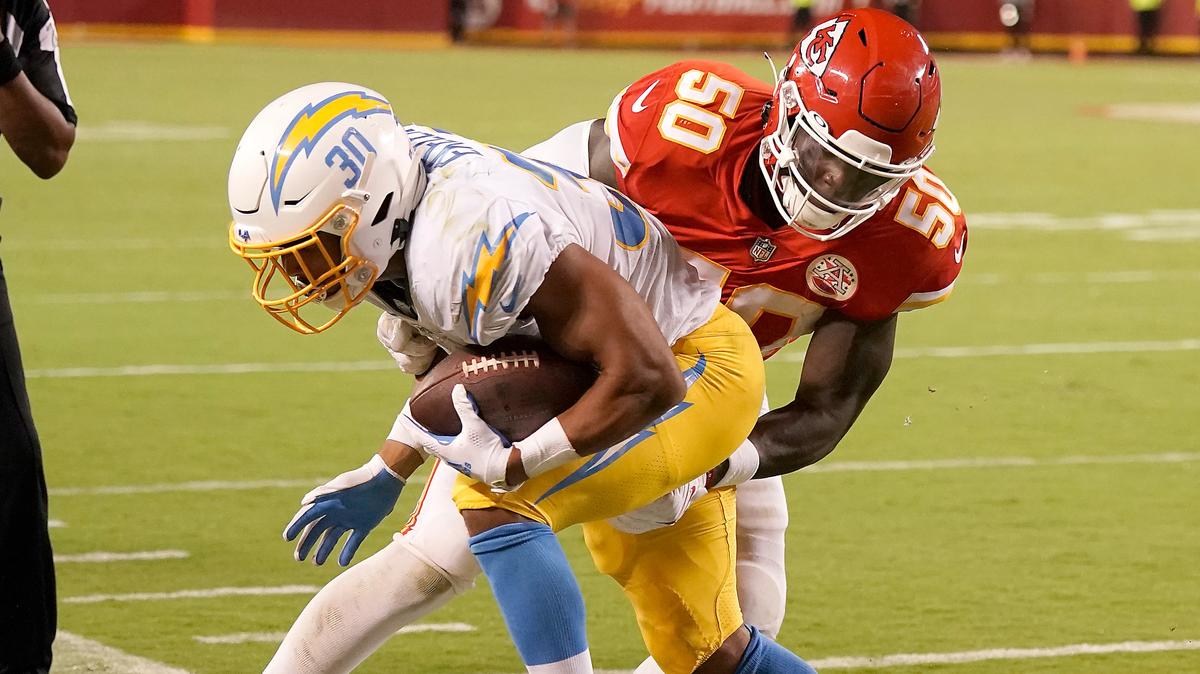 Kansas City Chiefs linebacker Willie Gay (50) tackles Los Angeles Chargers running back Austin Ekeler (30) during the second half of an NFL football game Thursday, Sept. 15, 2022, in Kansas City, Mo. The Chiefs won 27-24. (AP Photo/Charlie Riedel)