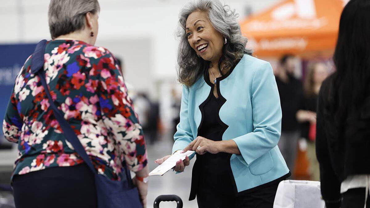 Marlene Lee, right, senior recruiter at Henderson Hospital, speaks with attendees at the Spring Job Fair at the Las Vegas Convention Center on March 13. U.S. job openings slipped in March amid a decline in professional and business services, but a surge in hiring to a more than two-year high suggested the labor market was regaining its footing after struggling in recent months.