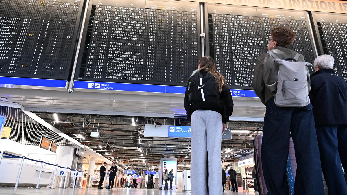 Passengers look at the announcement board showing cancelled flights at Frankfurt Airport in Frankfurt am Main, on April 10, 2026 as cabin crews of German airline Lufthansa went on strike over an ongoing labour dispute. (Kirill Kudryavtsev/AFP/Getty Images/TNS)