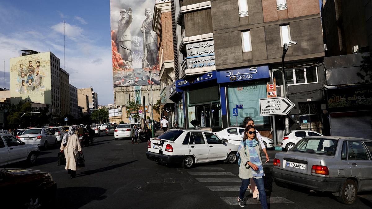 FILE PHOTO: People walk past a billboard about the Strait of Hormuz, in Tehran, Iran, May 17, 2026. Majid Asgaripour/WANA (West Asia News Agency) via REUTERS/File Photo