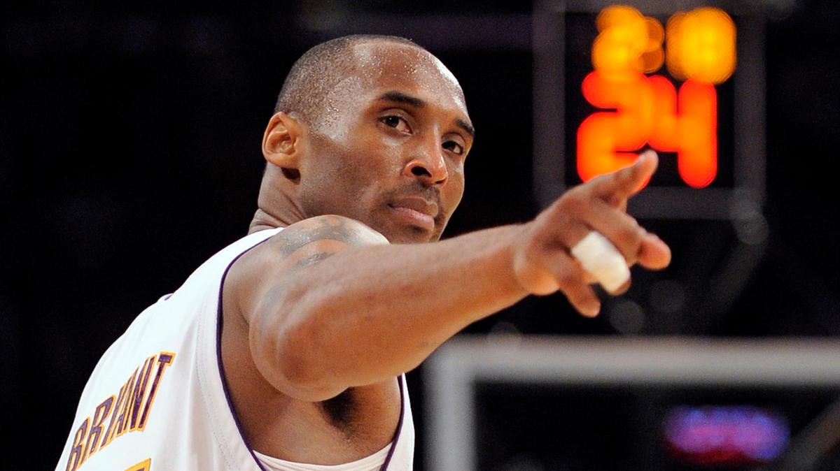 FILE - In this June 7, 2009, file photo, Los Angeles Lakers guard Kobe Bryant (24) points to a player behind him after making a basket in the closing seconds against the Orlando Magic in Game 2 of the NBA basketball finals in Los Angeles. Federal investigators said Wednesday, June 17, 2020, that the pilot of the helicopter that crashed in thick fog, killing Kobe Bryant and seven other passengers, reported he was climbing when he actually was descending. (AP Photo/Mark J. Terrill, File)