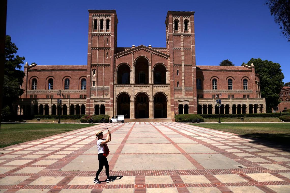 Royce Hall towers over a visitor in Dickson Plaza at UCLA in Westwood on Aug. 15, 2024.