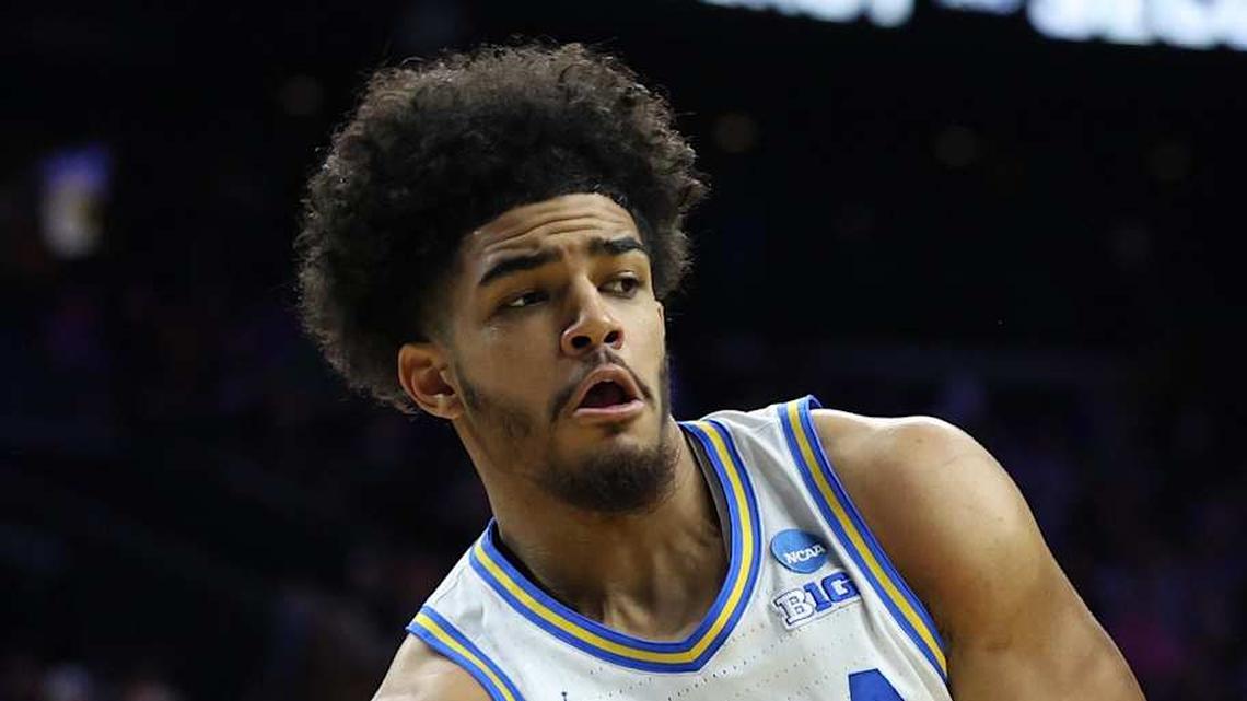  Mar 20, 2026; Philadelphia, PA, USA; UCLA Bruins guard Eric Freeny (8) makes a pass against UCF Knights center John Bol (7) in the second half during a first round game of the men's 2026 NCAA Tournament at Xfinity Mobile Arena. Mandatory Credit: Bill Streicher-Imagn Images | Bill Streicher-Imagn Images 
