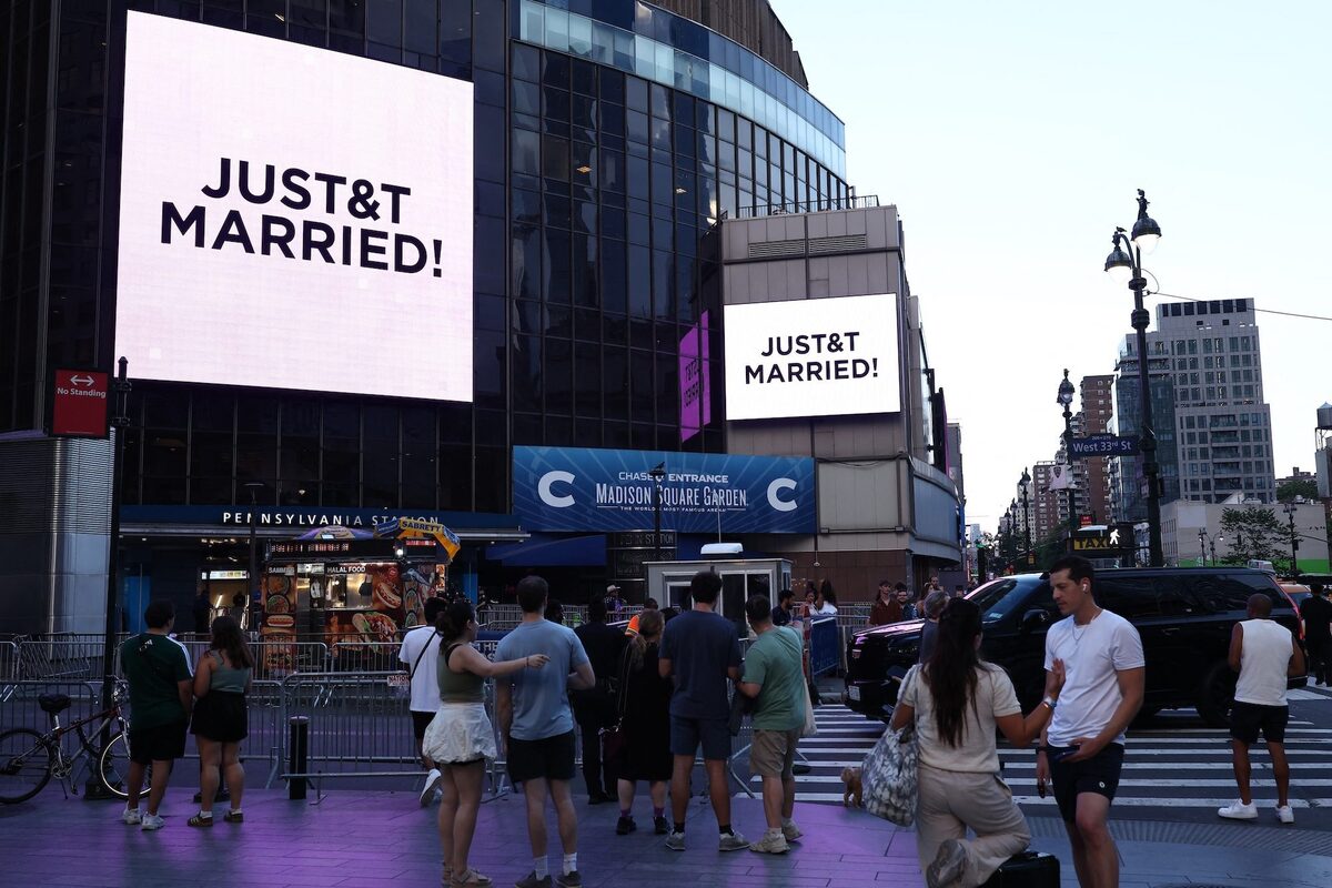 The message "JUST&T MARRIED!" is projected outside Madison Square Garden.