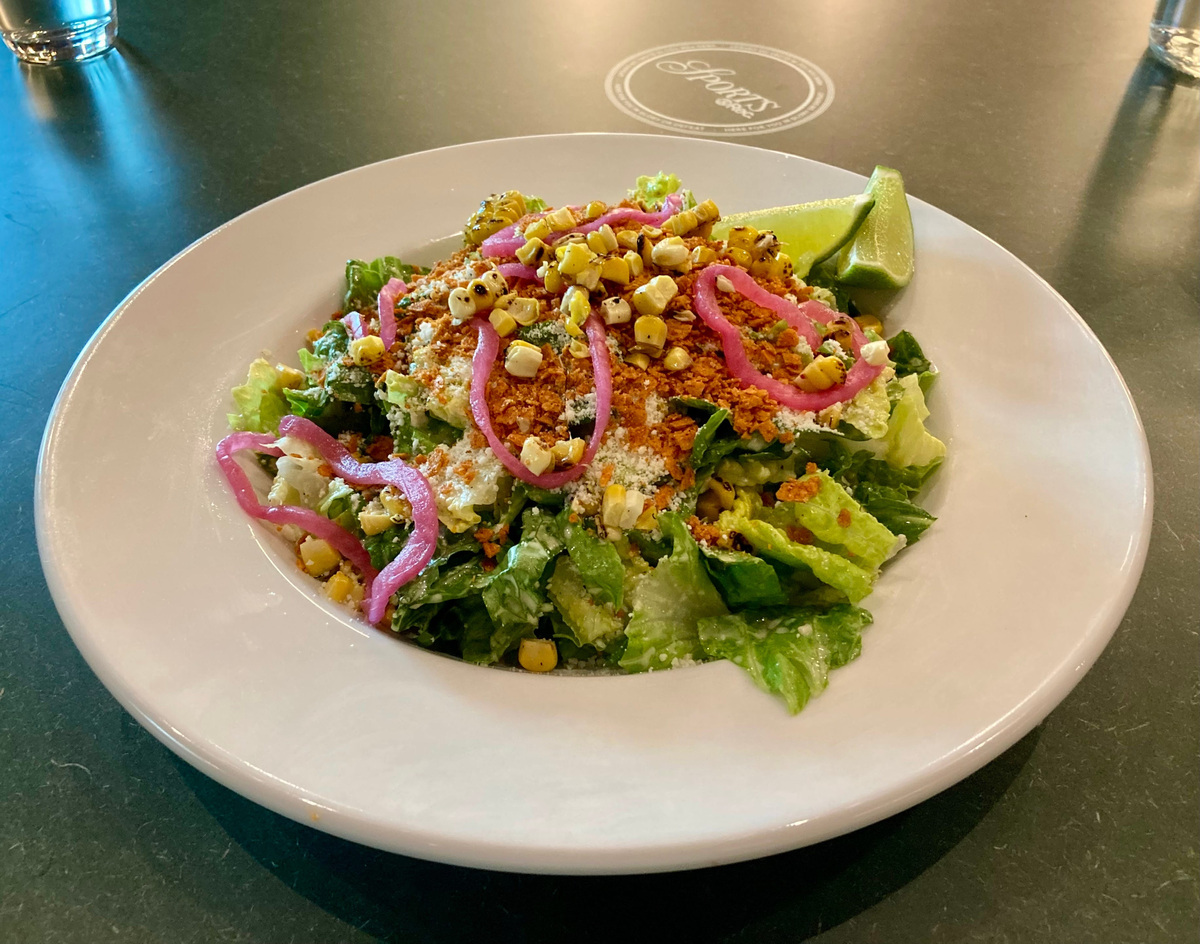 Much lighter than a traditional Caesar salad, the Elote Caesar at Sports & Rec is inspired by the traditional Mexican corn street food and features Romaine lettuce, charred corn, cotija cheese, tajin tortilla crisp and a lime Caesar dressing. Make sure you give those limes a nice squeeze for some delicious added pop.