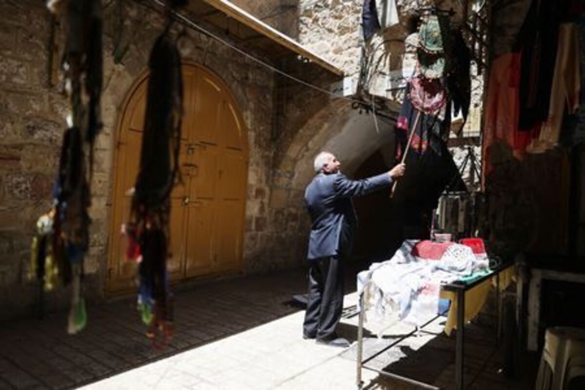 A man stands near the Ibrahimi Mosque, also known as the Cave of Patriarchs, in the old city of Hebron, in the Israeli-occupied West Bank, June 17, 2026. REUTERS/Ammar Awad