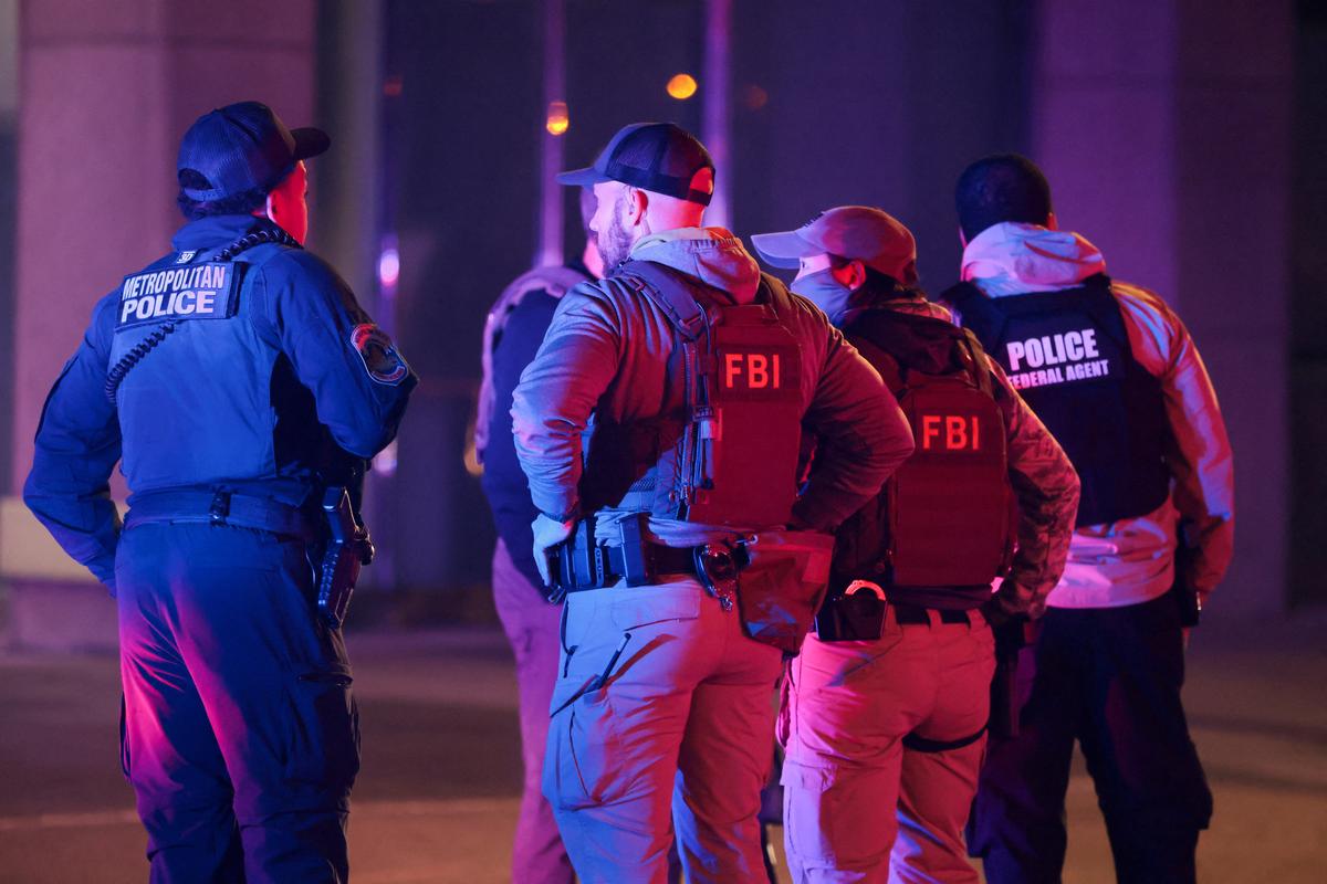FBI agents stand on the street after a shooting incident near the White House in Washington, D.C., U.S., May 23, 2026. REUTERS/Kylie Cooper