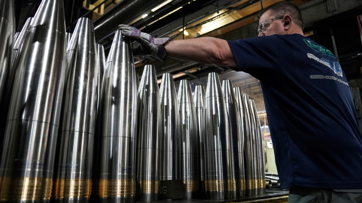 A worker along the assembly line handles large caliber 155mm metal projectiles at the Scranton Army Ammunition Plant in Scranton, Pennsylvania, U.S., April 16, 2024. REUTERS/Kevin Lamarque