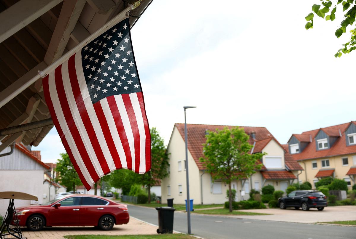A national flag of the United States hangs in front of a duplex house in Netzaberg housing area where personnel of the U.S. military and their families have their homes near Grafenwoehr military training area, around 20 kilometres north of Vilseck, in Netzaberg, Germany, May 5, 2026. REUTERS/Lisi Niesner