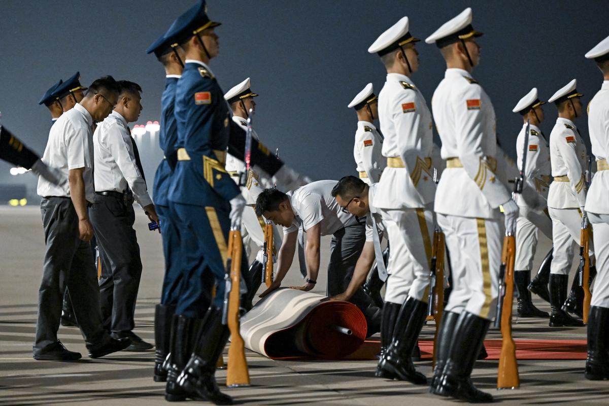 A red carpet is laid down as President Donald Trump arrives on Air Force One at Beijing Capital International Airport in Beijing, China, on Wednesday, May 13, 2026. Trump is in China for a two-day summit with China's leader, Xi Jinping. (Kenny Holston/The New York Times)
