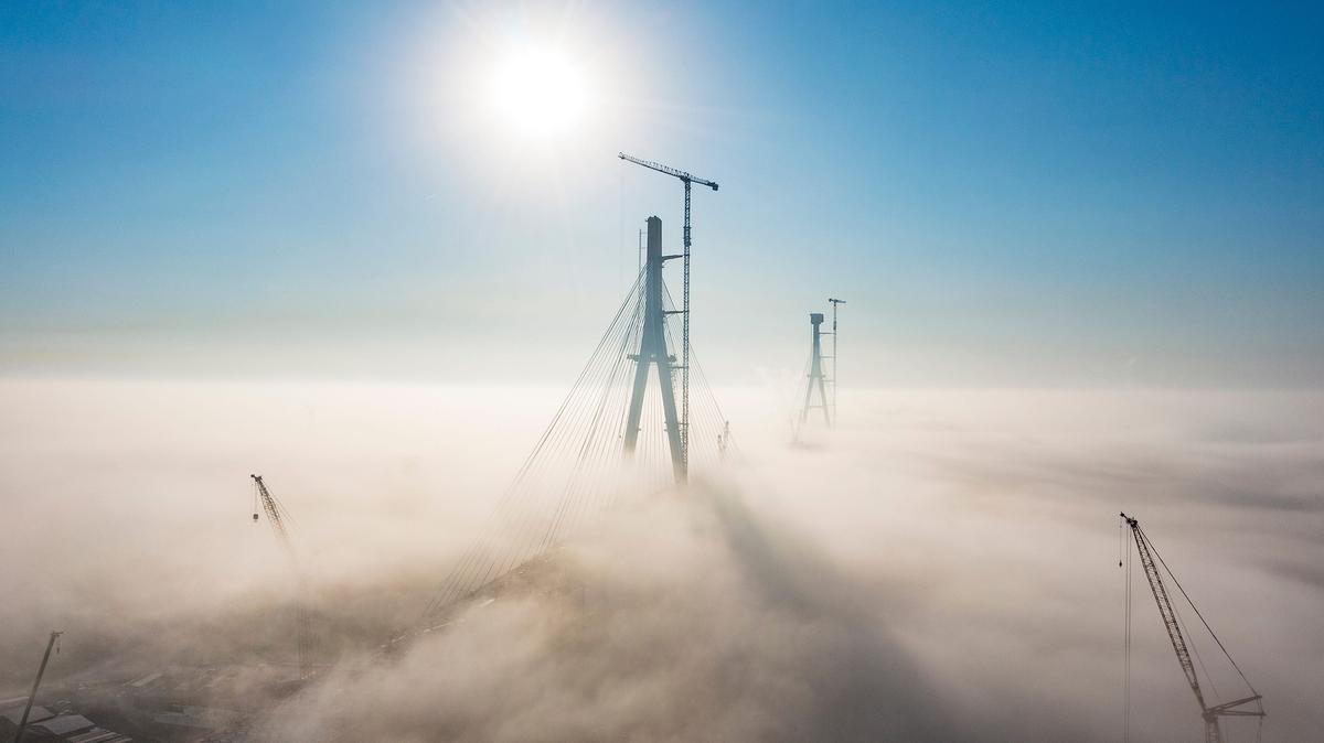 The sun begins to burn off low level fog around the Gordie Howe International Bridge, Tuesday, Oct. 3, 2023. (Andy Morrison/The Detroit News/TNS)
