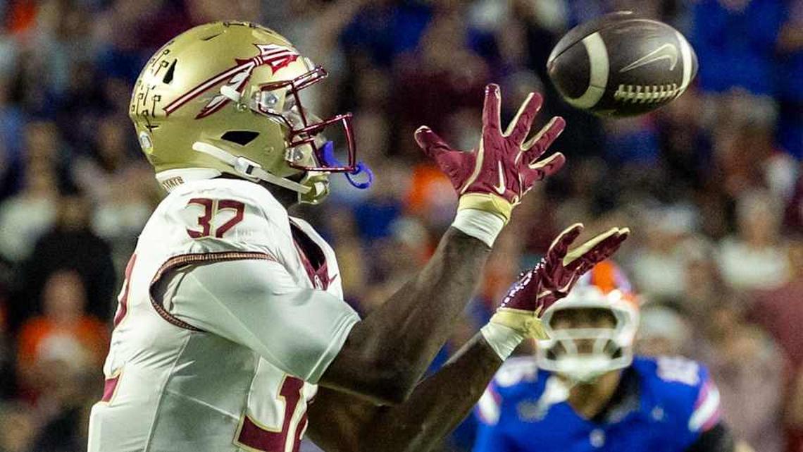  Nov 29, 2025; Gainesville, Florida, USA; Florida State Seminoles running back Ousmane Kromah (32) drops the ball during the second quarter against the Florida Gators at Ben Hill Griffin Stadium. Mandatory Credit: Bob Kupbens-Imagn Images | Bob Kupbens-Imagn Images 