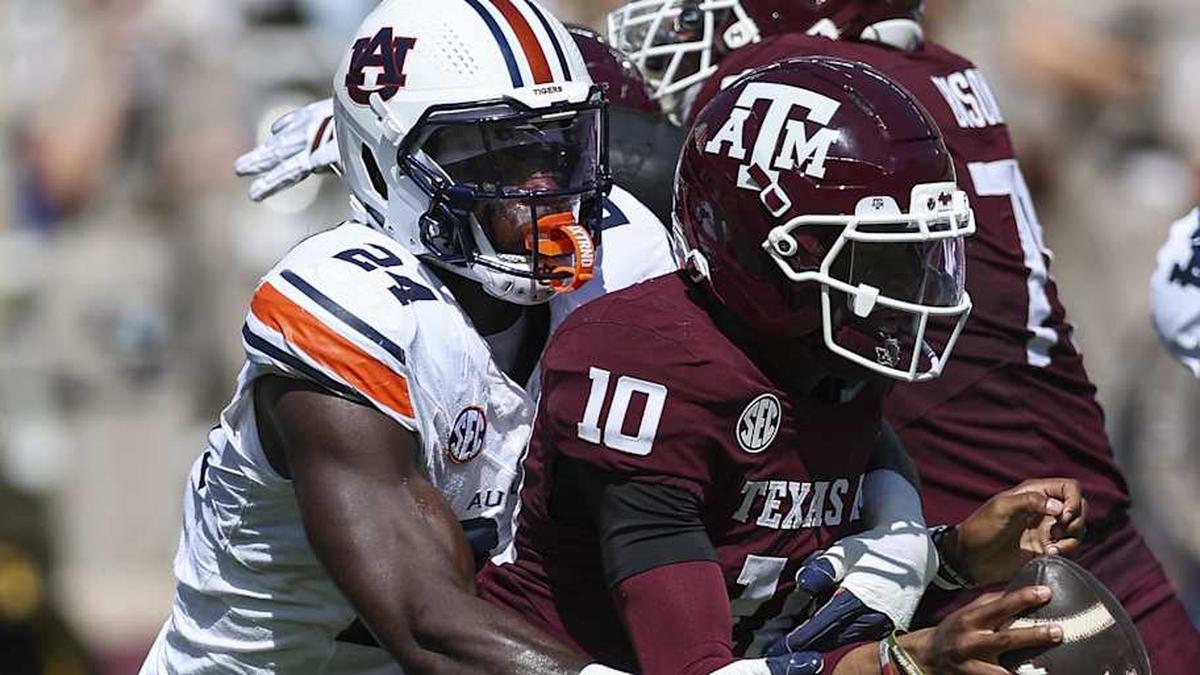  Sep 27, 2025; College Station, Texas, USA; Texas A&M Aggies quarterback Marcel Reed (10) is tackled by Auburn Tigers defensive end Keyron Crawford (24) during the second quarter at Kyle Field. Mandatory Credit: Troy Taormina-Imagn Images | Troy Taormina-Imagn Images 