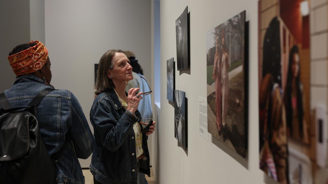 People view photographic prints displayed in the gallery space at the new Leica Store & Gallery Chicago at 800 N. Michigan Ave., during a photo exhibit reception April 16, 2026. (John J. Kim/Chicago Tribune)