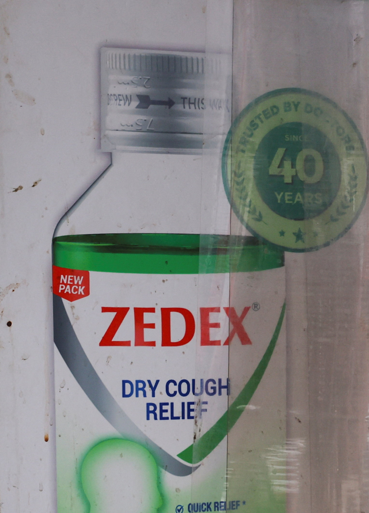 A man walks near a chemist shop featuring an advertisement for a cough syrup in New Delhi, India, June 16, 2026, 2026. REUTERS/Anushree Fadnavis