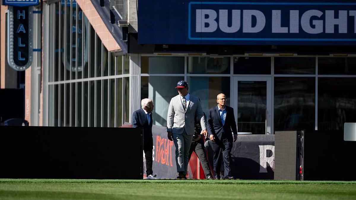  May 7, 2026; Foxborough, MA, USA; New England Patriots owner Robert Kraft (l) and Patriots president Jonathan Kraft (r) walk with first round draft pick Caleb Lomu (c) to the podium for a press conference on the game field at Gillette Stadium. Mandatory Credit: Natalie Reid-Imagn Images | Natalie Reid-Imagn Images 