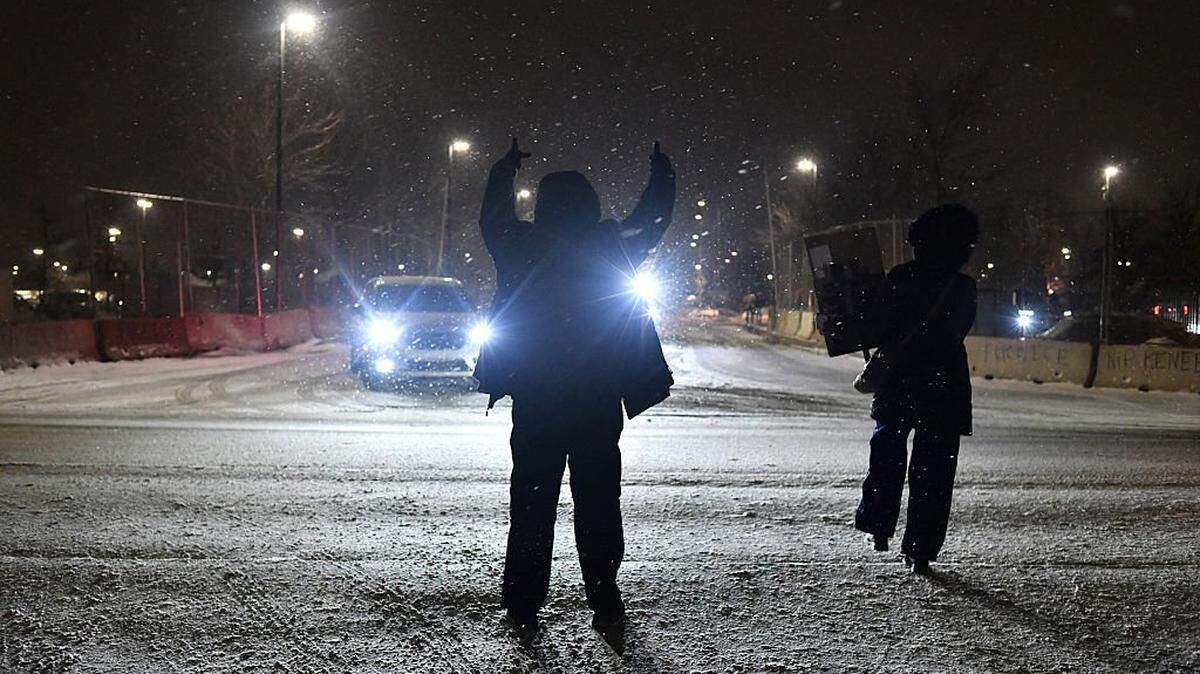 Anti-ICE demonstrators protest as Immigration and Customs Enforcement agents exit the Bishop Whipple Federal Building parking lot while carrying out detentions in Minneapolis, Minnesota, on January 16.