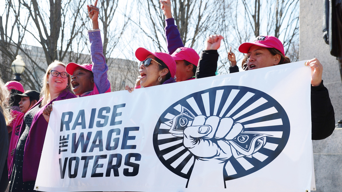 Activists raise fists in support of the One Fair Wage movement outside the Illinois State Capitol in Springfield, Ill., Feb. 6, 2024. The minimum wage for tipped workers will increase to $12.96 on July 1, a very slight increase from the current hourly minimum of $12.62. Tipped workers whose tips do not bring them up to the full minimum wage must be paid the difference by their employer. (Stacey Wescott/Chicago Tribune/TNS)