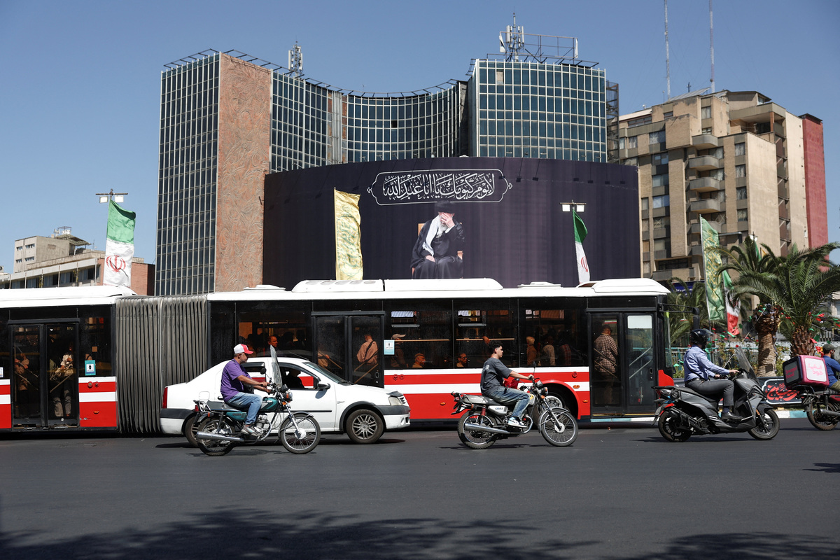 People drive past a billboard with a picture of the late Iran's Supreme Leader Ayatollah Ali Khamenei, after U.S. and Iranian officials said they had reached a deal to end their war and reopen the Strait of Hormuz, in Tehran, Iran, June 15, 2026. Majid Asgaripour/WANA (West Asia News Agency) via REUTERS