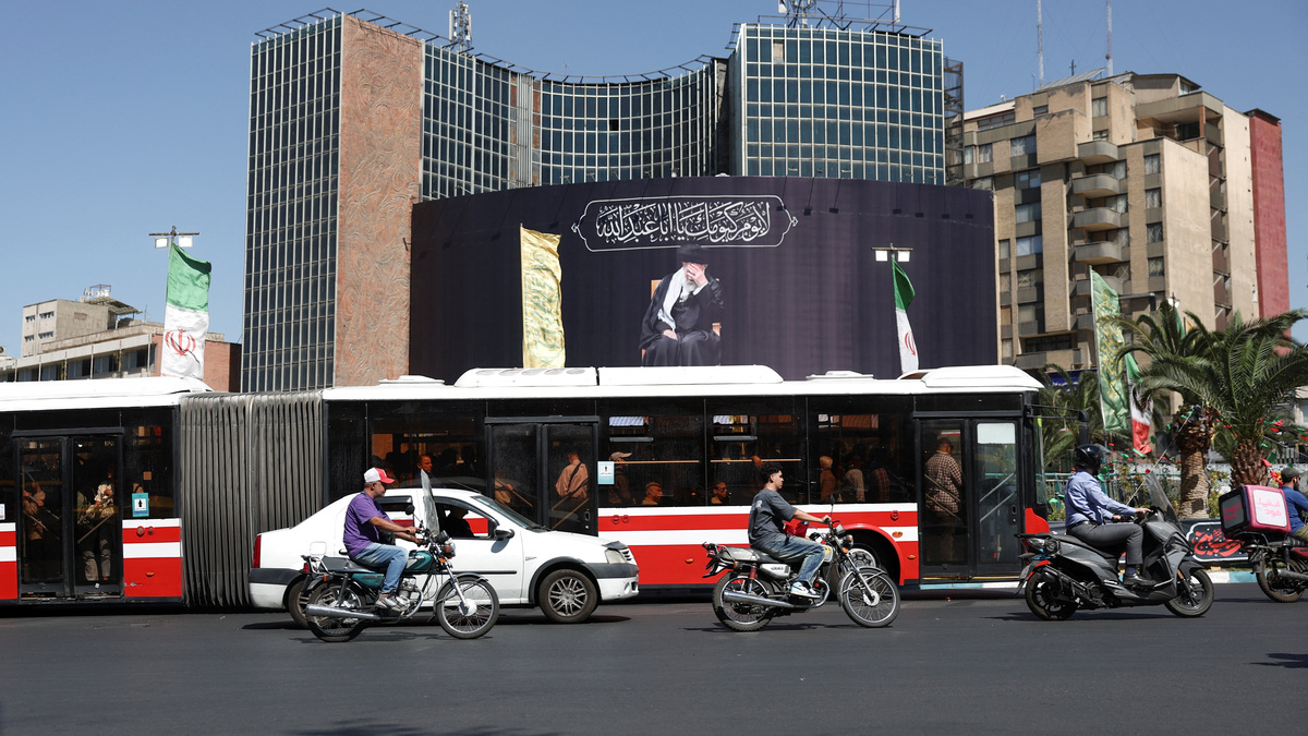People drive past a billboard with a picture of the late Iran's Supreme Leader Ayatollah Ali Khamenei, after U.S. and Iranian officials said they had reached a deal to end their war and reopen the Strait of Hormuz, in Tehran, Iran, June 15, 2026. Majid Asgaripour/WANA (West Asia News Agency) via REUTERS