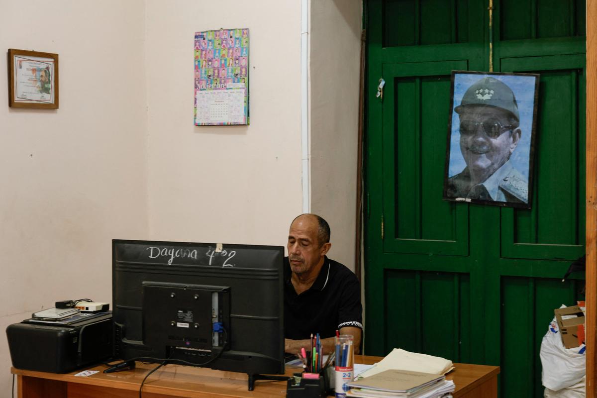A man works in a school beside an image of former Cuban President Raul Castro, who has been indicted in the United States in a move that marks an escalation in Washington's pressure campaign against the Caribbean island's communist government, Havana, Cuba, May 20, 2026. REUTERS/Norlys Perez