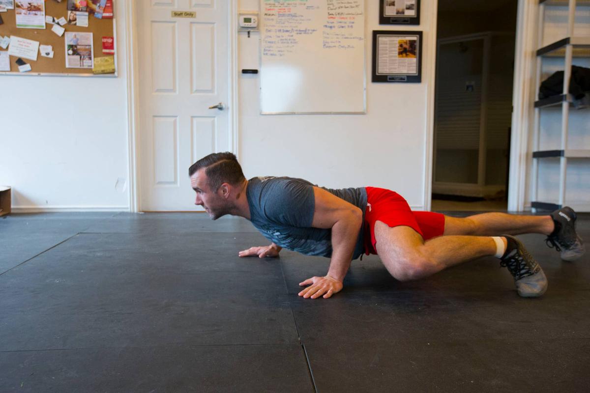  TORONTO, ON - DECEMBER 30: Spiderman walk demonstrated by Jordan Symonds, co-owner and head coach at Reebok Crossfit in Liberty Village demonstrates bodyweight exercises that people can perform with minimal equipment. (Chris So/Toronto Star via Getty Images).