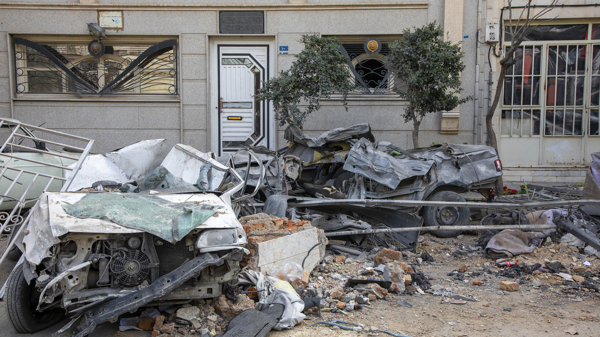 Destroyed vehicles lie near a residential building hit in an airstrike earlier Monday morning on March 30, 2026, in the west of Tehran, Iran. The United States and Israel have continued their joint attack on Iran that began on Feb. 28. 