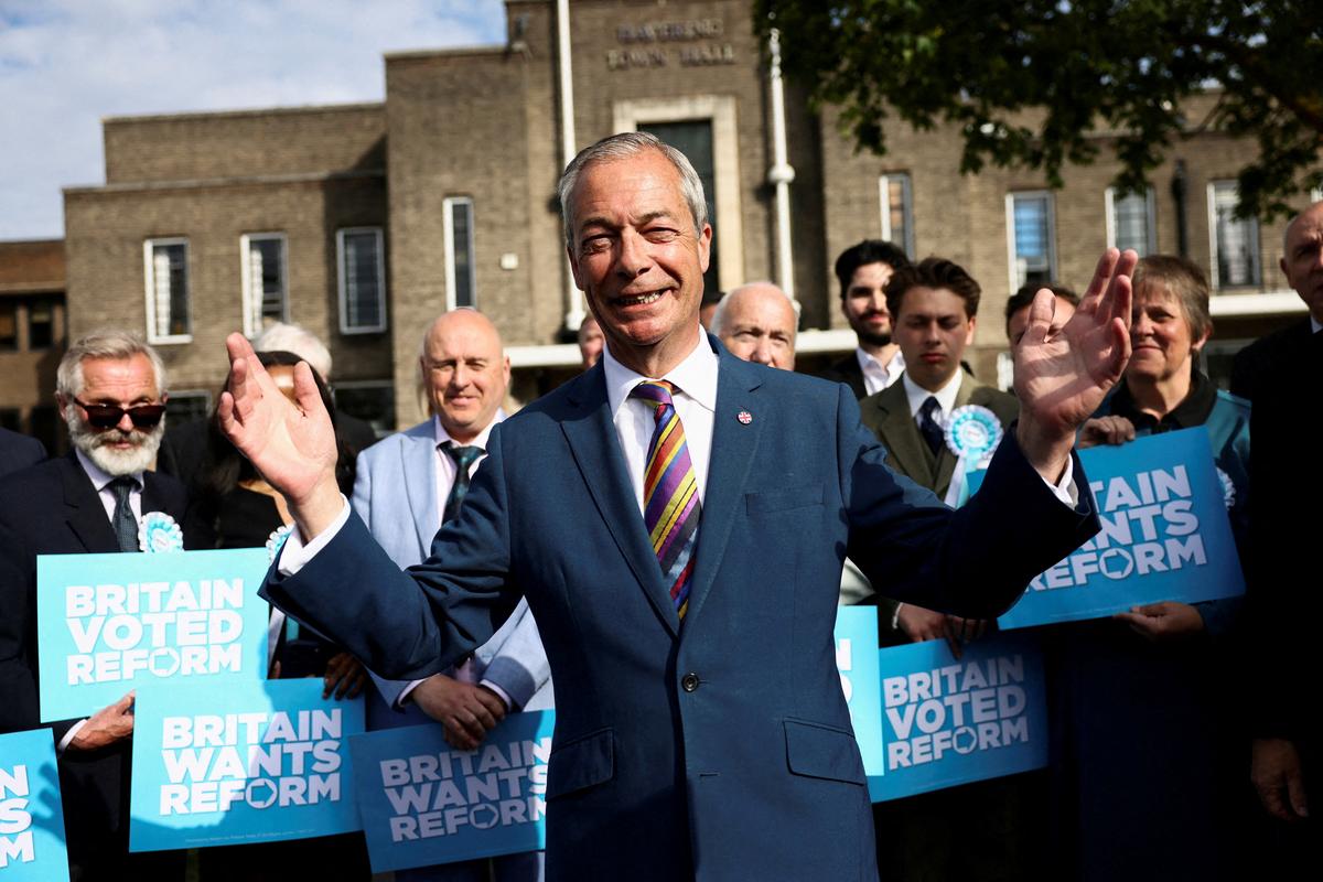 Britain's Reform UK leader Nigel Farage reacts next to newly elected councillors at the Havering Town Hall, following the results of the local elections, in the London Borough of Havering, Britain, May 8, 2026. REUTERS/Jack Taylor