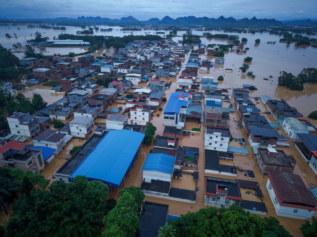 A drone view shows buildings partially submerged in floodwaters after heavy rainfall brought by typhoon Maysak, in Hengzhou, Guangxi Zhuang Autonomous Region, China July 6, 2026. China Daily via REUTERS