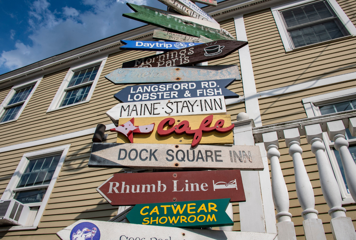  Signs point to stores and restaurants in Kennebunkport, Maine, on July 22, 2022. 
