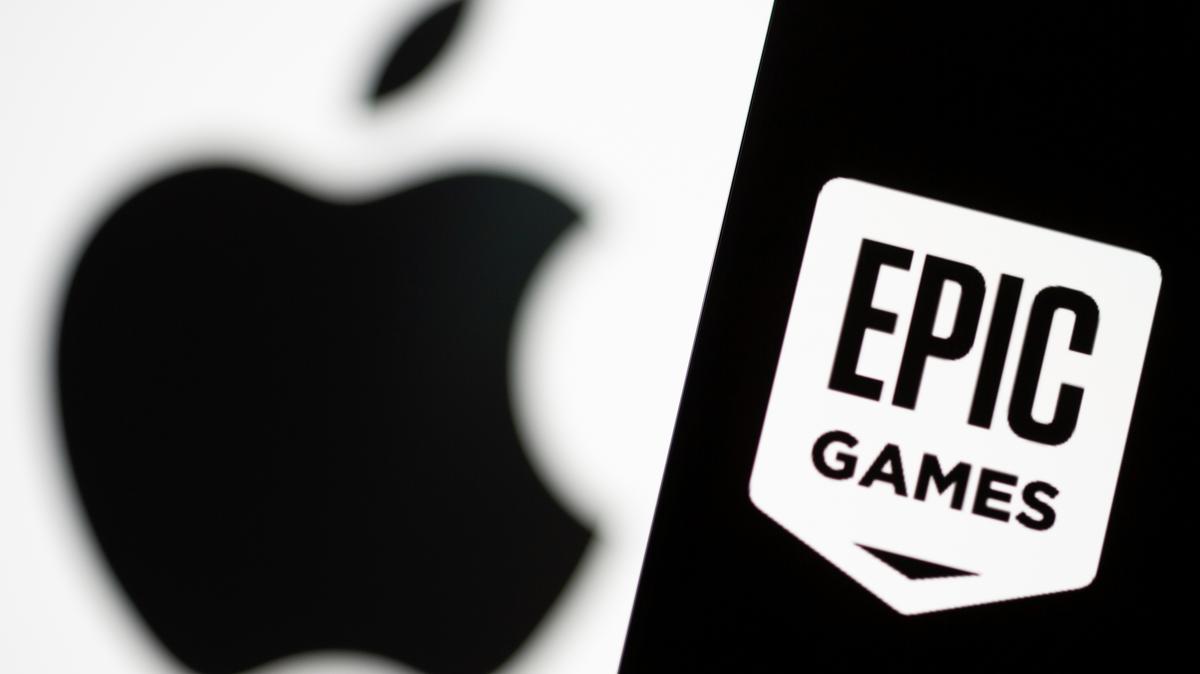 Smartphone with Epic Games logo is seen in front of Apple logo in this illustration taken, May 2, 2021. REUTERS/Dado Ruvic/Illustration