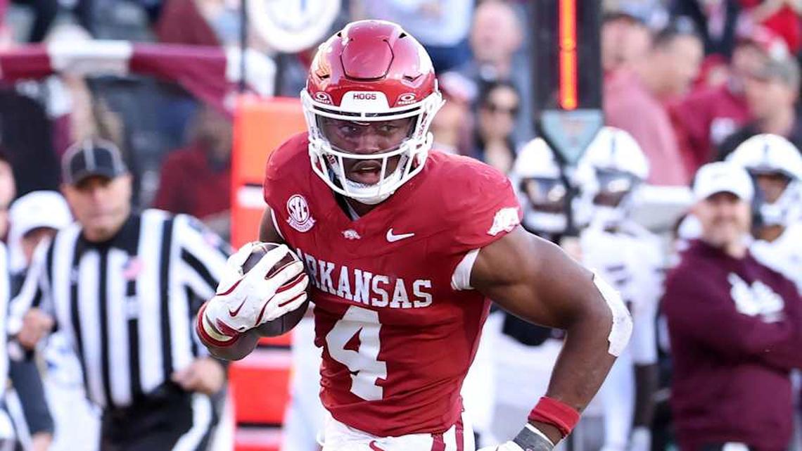  Nov 1, 2025; Fayetteville, Arkansas, USA; Arkansas Razorbacks running back Mike Washington Jr (4) rushes for a touchdown during the third quarter against the Mississippi State Bulldogs at Donald W. Reynolds Razorback Stadium. Bulldogs won 38-35. Mandatory Credit: Nelson Chenault-Imagn Images | Nelson Chenault-Imagn Images 