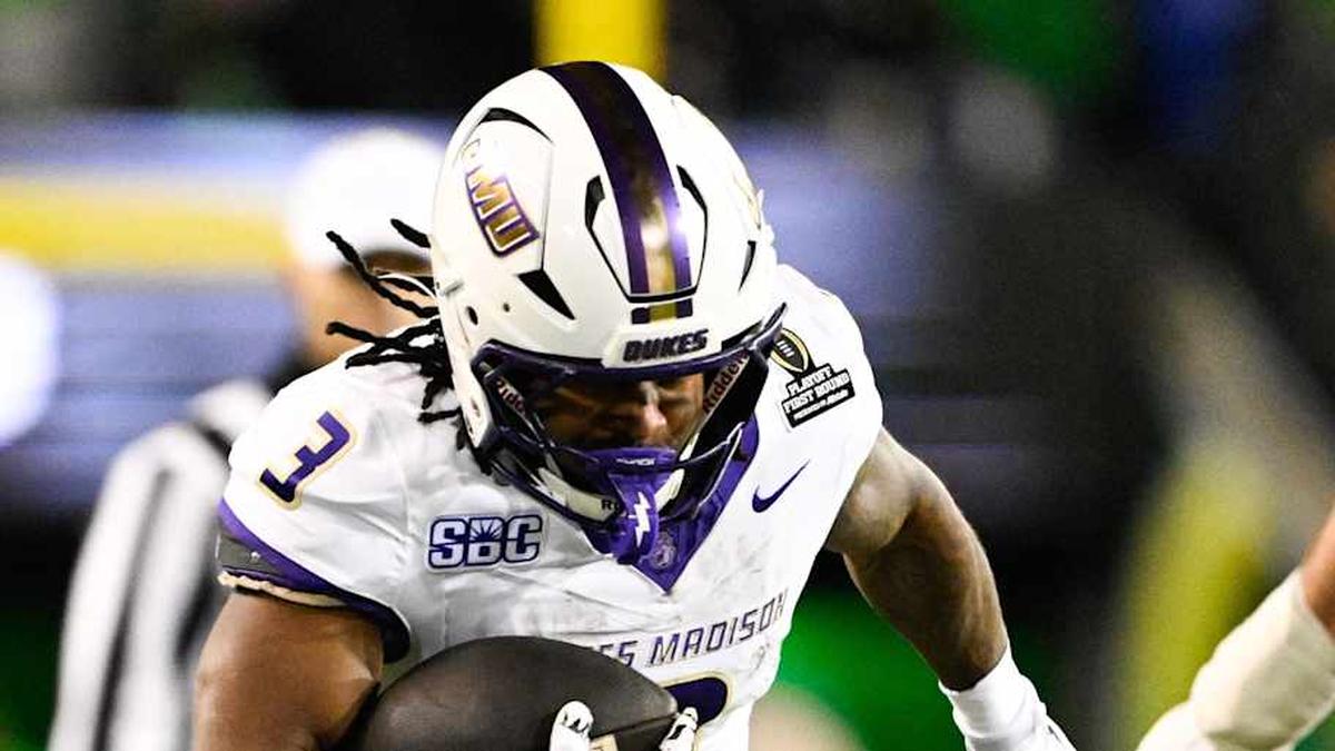  Dec 20, 2025; Eugene, OR, USA; James Madison Dukes running back Wayne Knight (3) rushes as Oregon Ducks defensive back Aaron Flowers (21) defends during the second quarter at Autzen Stadium. Mandatory Credit: Troy Wayrynen-Imagn Images | Troy Wayrynen-Imagn Images 