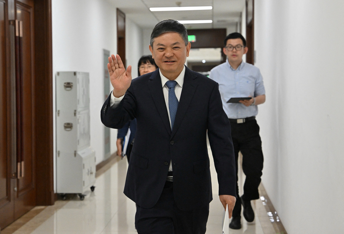 Huang Runqiu, China’s Minister of Ecology and Environment gestures towards the media prior to a meeting at the Ministry of Ecology and Environment office in Beijing on May 30, 2025.  ADEK BERRY/Pool via REUTERS