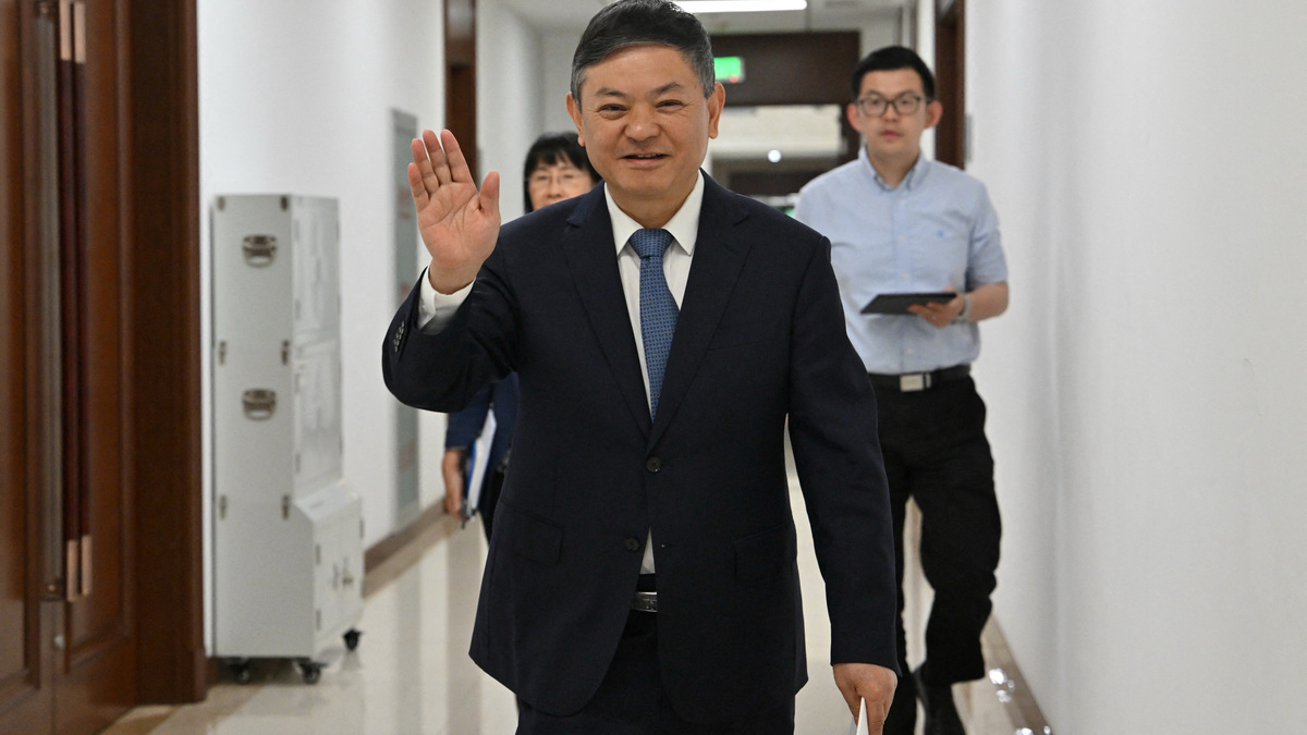 Huang Runqiu, China’s Minister of Ecology and Environment gestures towards the media prior to a meeting at the Ministry of Ecology and Environment office in Beijing on May 30, 2025.  ADEK BERRY/Pool via REUTERS