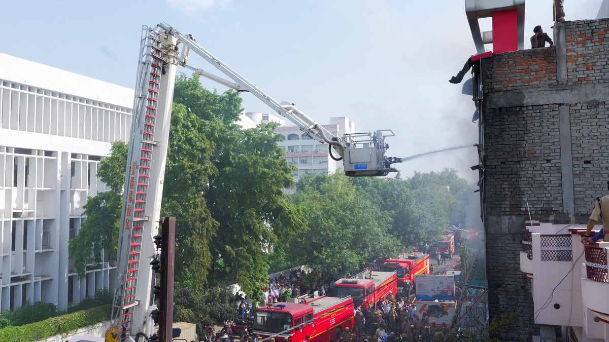 Firefighters douse a deadly fire at a coaching centre in Lucknow, India, June 22, 2026. REUTERS/STRINGER