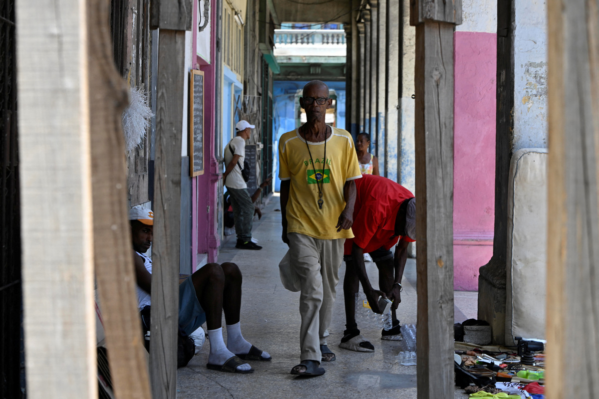 Sagrado Armando Garcia, 85, a retired government bureaucrat, walks home from a state-run dining hall that provides rations to the people in need in Havana, Cuba, April 28, 2026. Garcia spent decades working at Cuba's Ministry of Social Security, believing in a system that promised to shield people in old age. That sense of security has vanished as Cuba has struggled for years under U.S. sanctions to provide basic services, with seniors now facing harsher conditions after the Trump administration's move to cut off the island's fuel supply. REUTERS/Norlys Perez