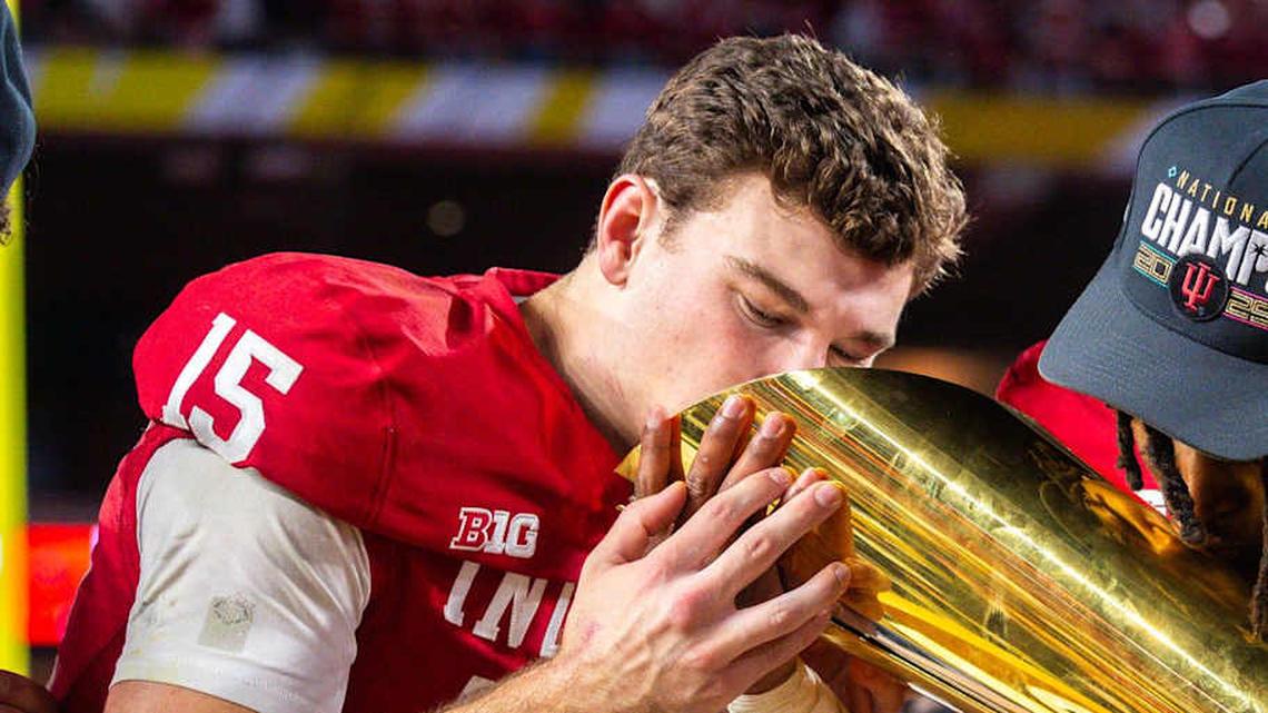  Indiana's Fernando Mendoza (15) an D'Angelo Ponds (5) kiss the trophy after the College Football Playoff National Championship college football game at Hard Rock Stadium in Miami Gardens on Monday, Jan. 19, 2026. | Rich Janzaruk/Herald-Times / USA TODAY NETWORK via Imagn Images 