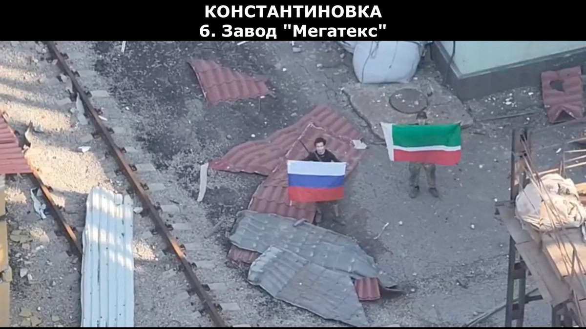 A drone view shows soldiers holding up a Russian and Chechen Republic flags, as the Russian defence ministry says its forces had taken control of Kostiantynivka, in the course of the Russia-Ukraine conflict, in the Donetsk region, Ukraine in this screen grab from handout video released July 3, 2026. Russian Defence Ministry/Handout via REUTERS