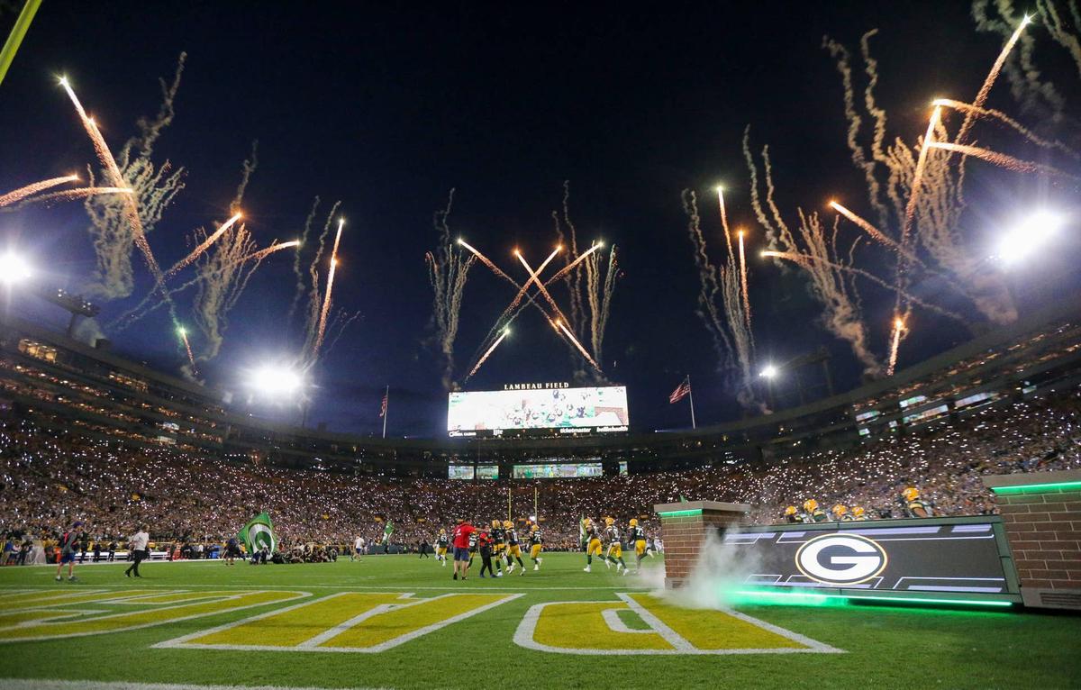  Fireworks are fired off as the Green Bay Packers run out of the tunnel before their football game against the Detroit Lions at Lambeau Field in Green Bay, Wisconsin. 