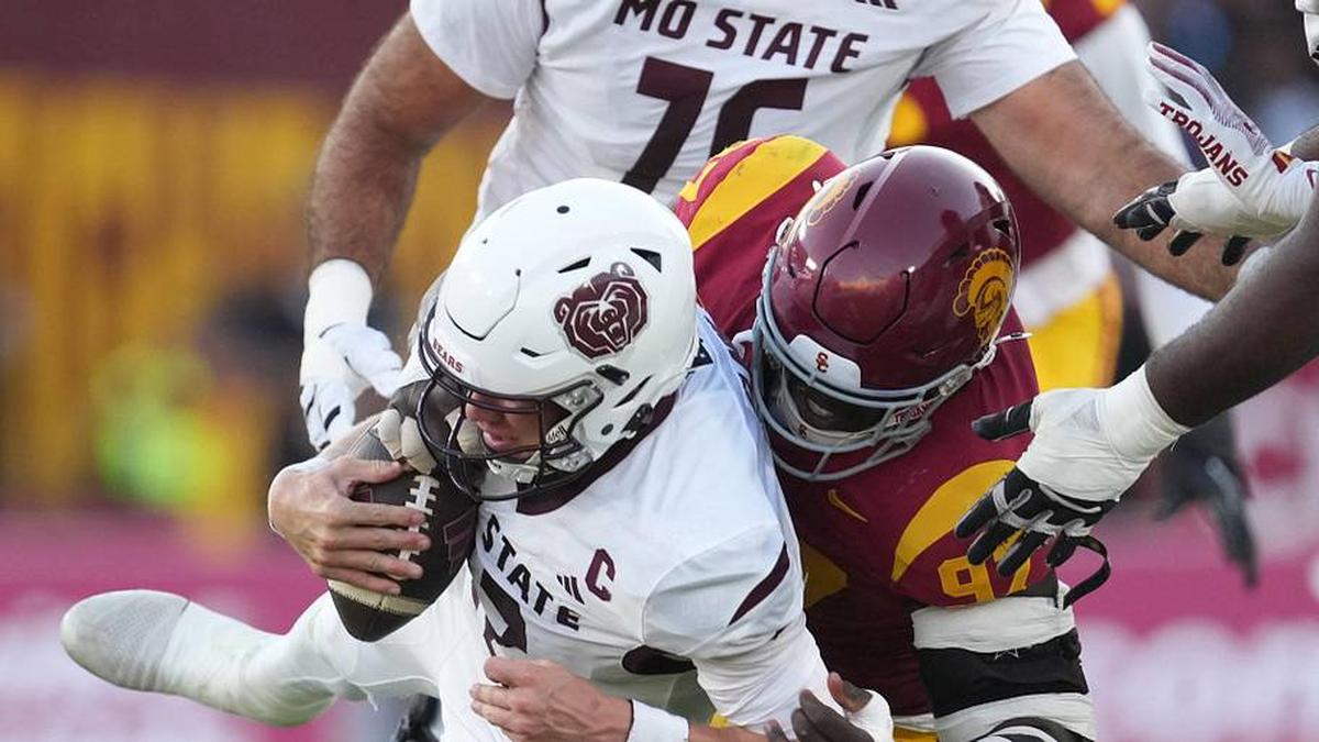  Aug 30, 2025; Los Angeles, California, USA; Missouri State Bears quarterback Jacob Clark (12) is sacked by Southern California Trojans defensive tackle Jide Abasiri (97) in the second half at United Airlines Field at Los Angeles Memorial Coliseum. Mandatory Credit: Kirby Lee-Imagn Images | Kirby Lee-Imagn Images 