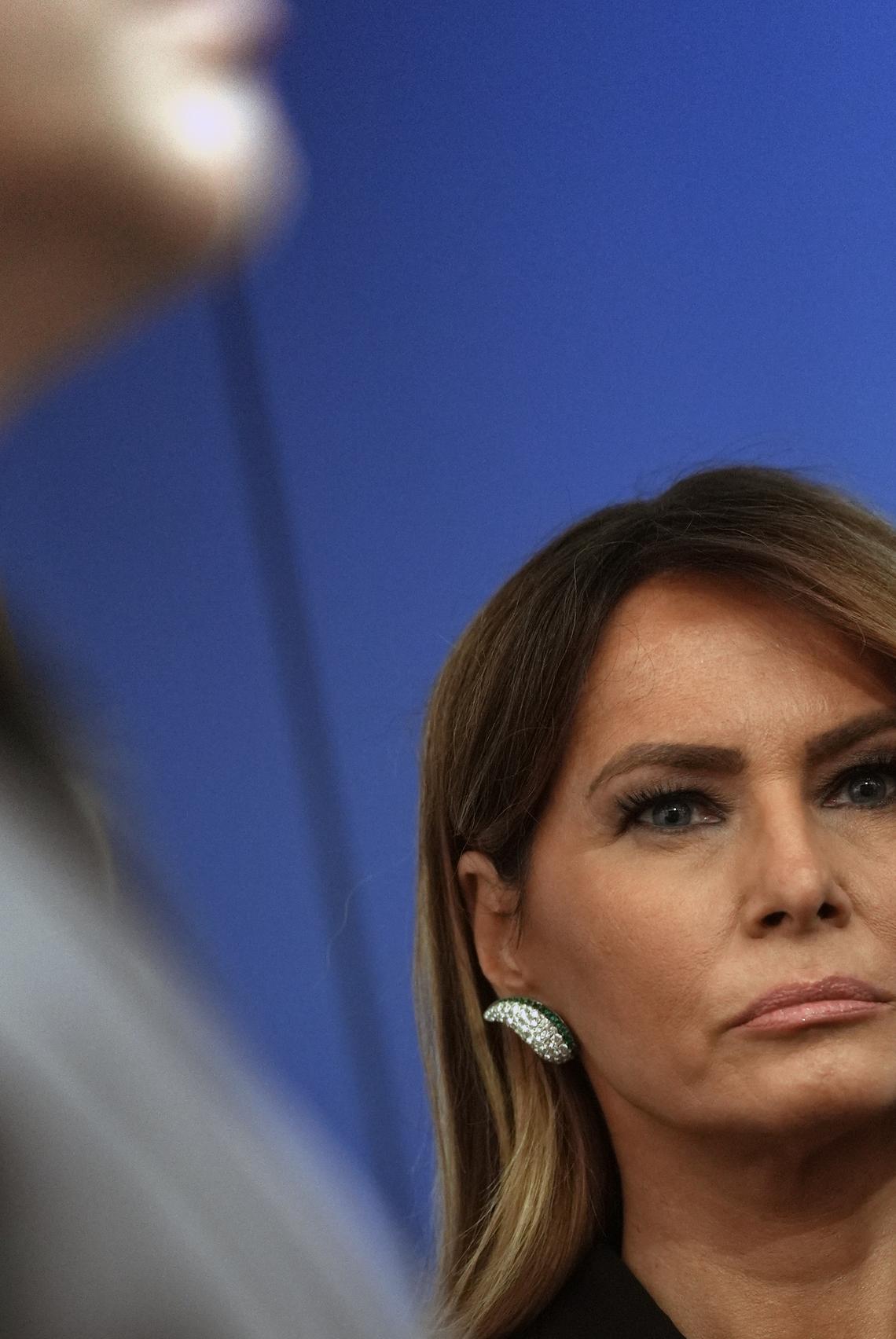 First lady Melania Trump looks on as President Donald Trump briefs reporters at the White House after shots were fired during the White House Correspondents' Association dinner at the Washington Hilton in Washington on Saturday, April 25, 2026. Trump was rushed from the stage but was unharmed. (Salwan Georges/The New York Times)