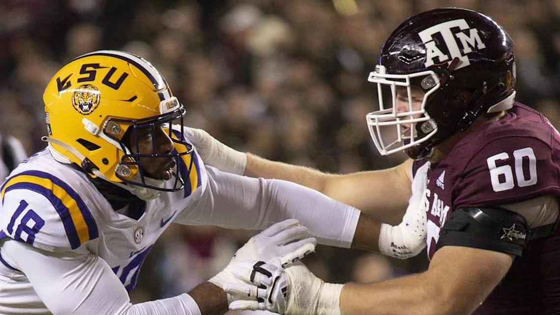  Nov 26, 2022; College Station, Texas, USA; Texas A&M Aggies offensive lineman Trey Zuhn III (60) blocks LSU Tigers defensive end BJ Ojulari (18) during the first quarter at Kyle Field. Mandatory Credit: Jerome Miron-Imagn Images | Jerome Miron-Imagn Images 