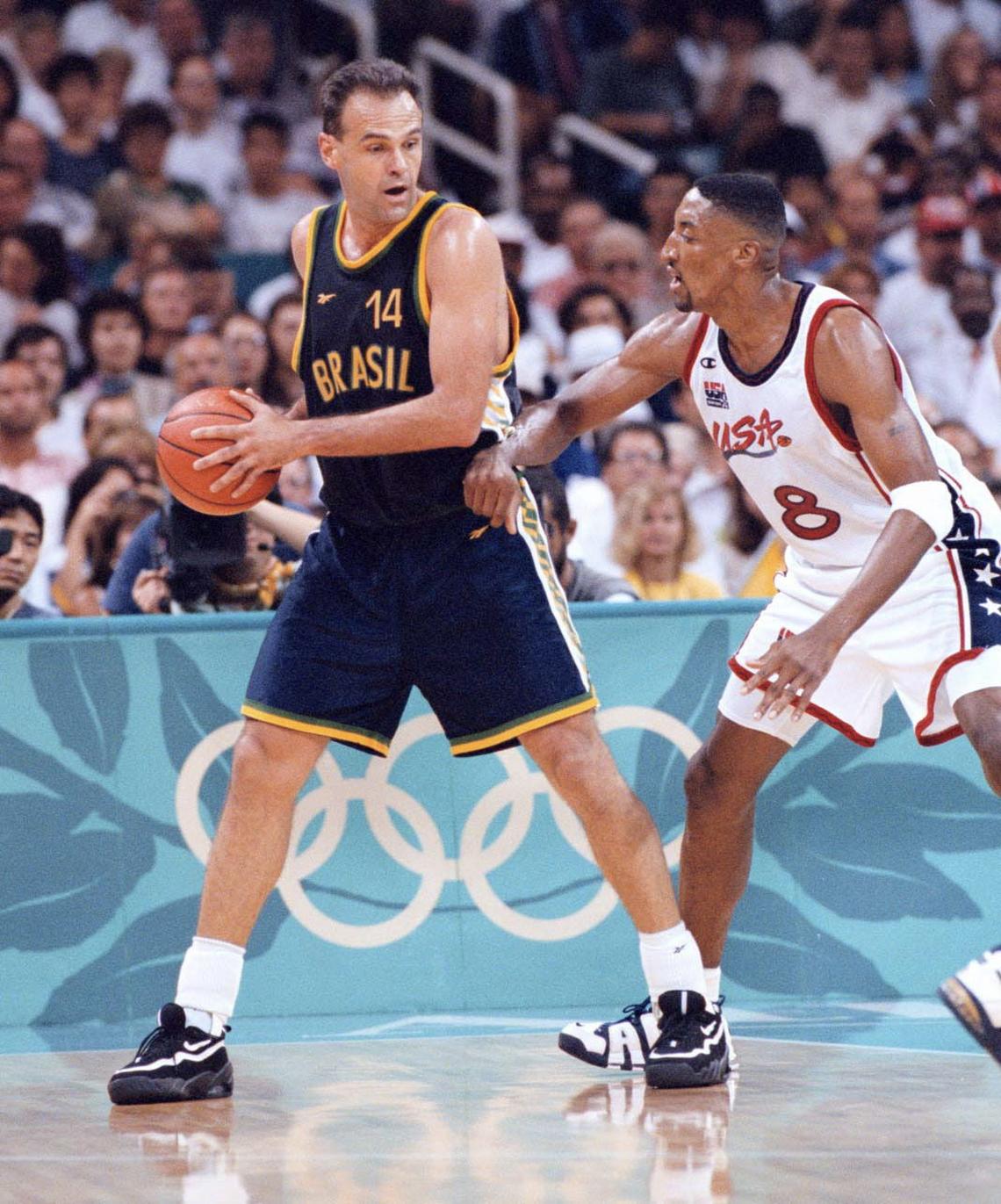 FILE -- Oscar Schmidt of Brazil protects the basketball from Scottie Pippen of the U.S., during a mens' quarterfinal at Summer Olympics in Atlanta on July 30, 1996. Schmidt, who was nicknamed the Holy Hand for shooting prowess and was widely regarded as the best player never to play in the NBA, died in Santana de Parnaiba, Brazil on April 17, 2026. He was 68. (Jose R. Lopez/The New York Times) ..