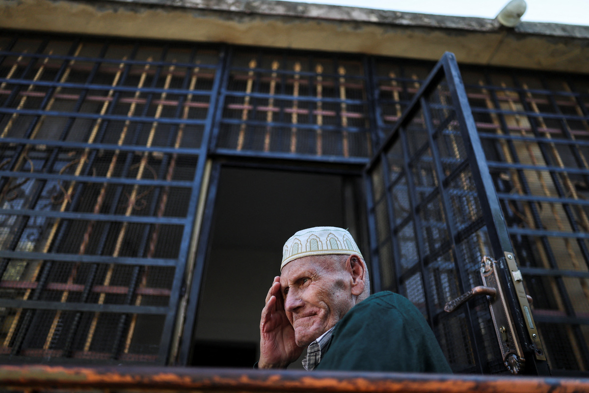 Palestinian grandfather Yousef Foqahaa sits outside his family home, whose windows they barred after Israeli settlers threw a Molotov cocktail inside two years ago while the family was home, in Sinjil, near Ramallah, in the Israeli-occupied West Bank, June 26, 2026. REUTERS/Ammar Awad