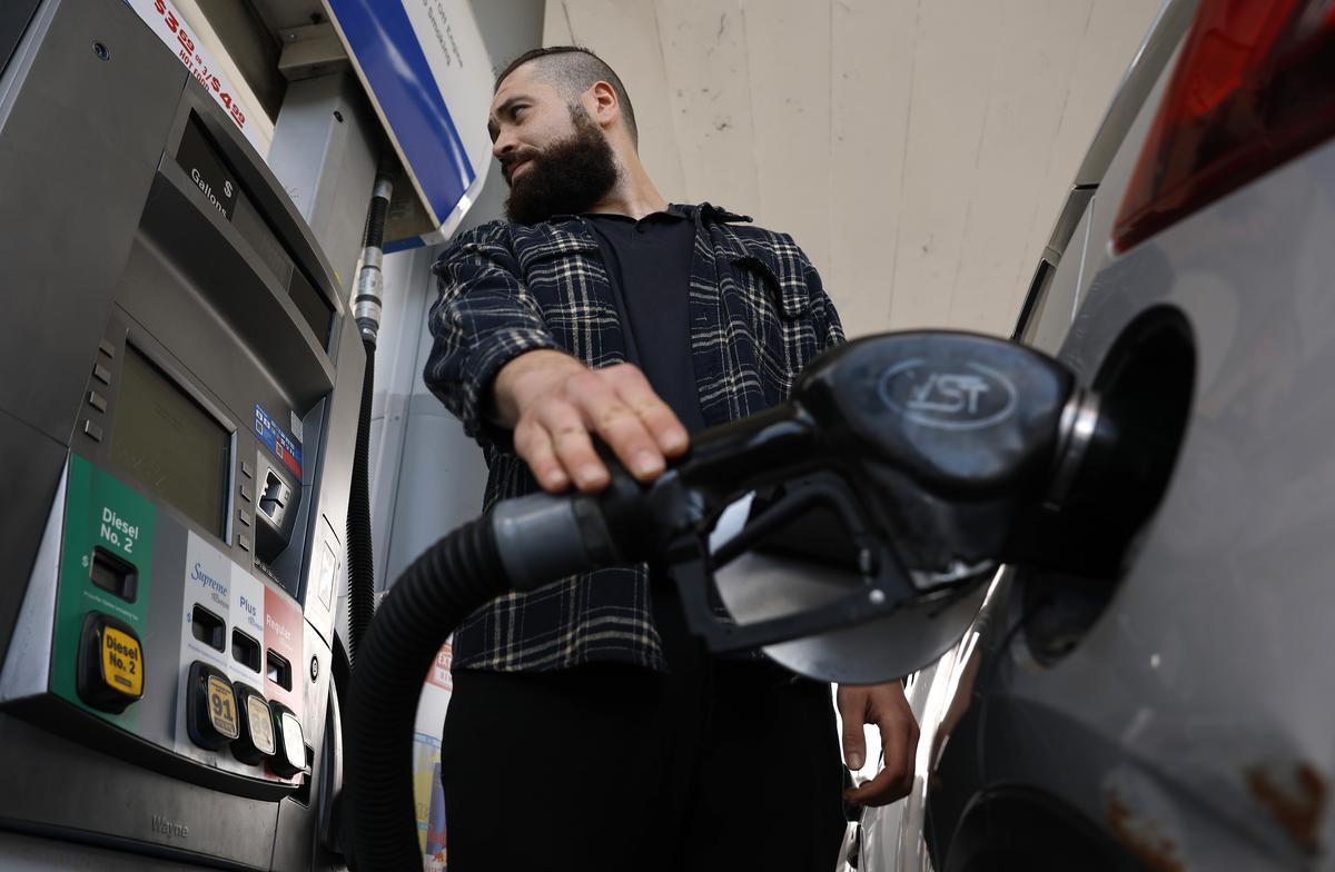  A customer pumps gas into his car at a Chevron station on May 4 in Los Angeles. 