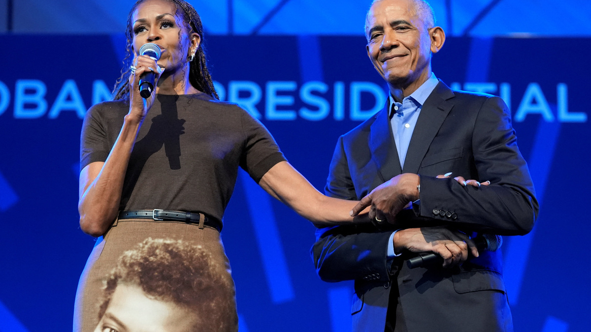 Former U.S. President Barack Obama and former U.S. first lady Michelle Obama hold hands as they deliver remarks at a stakeholders event at the Obama Presidential Centre in Chicago, Illinois, U.S., June 16, 2026. Pablo Martinez Monsivais/Pool via REUTERS