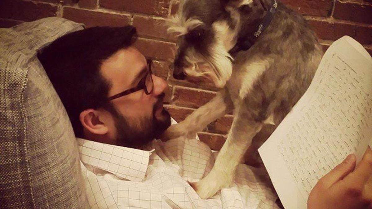 Truman, a schnauzer that spends his days at Kansas City Academy, interrupts while Head of School Kory Gallagher attempts to grade some papers.
