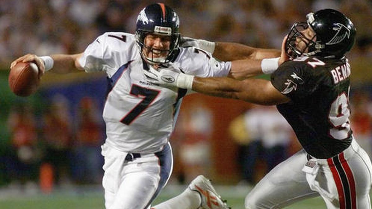 FILE - In this Jan. 31, 1999, file photo, Denver Broncos quarterback John Elway (7) stiff-arms Atlanta Falcons linebacker Cornelius Bennett during the third quarter of Super Bowl XXXIII in Miami.